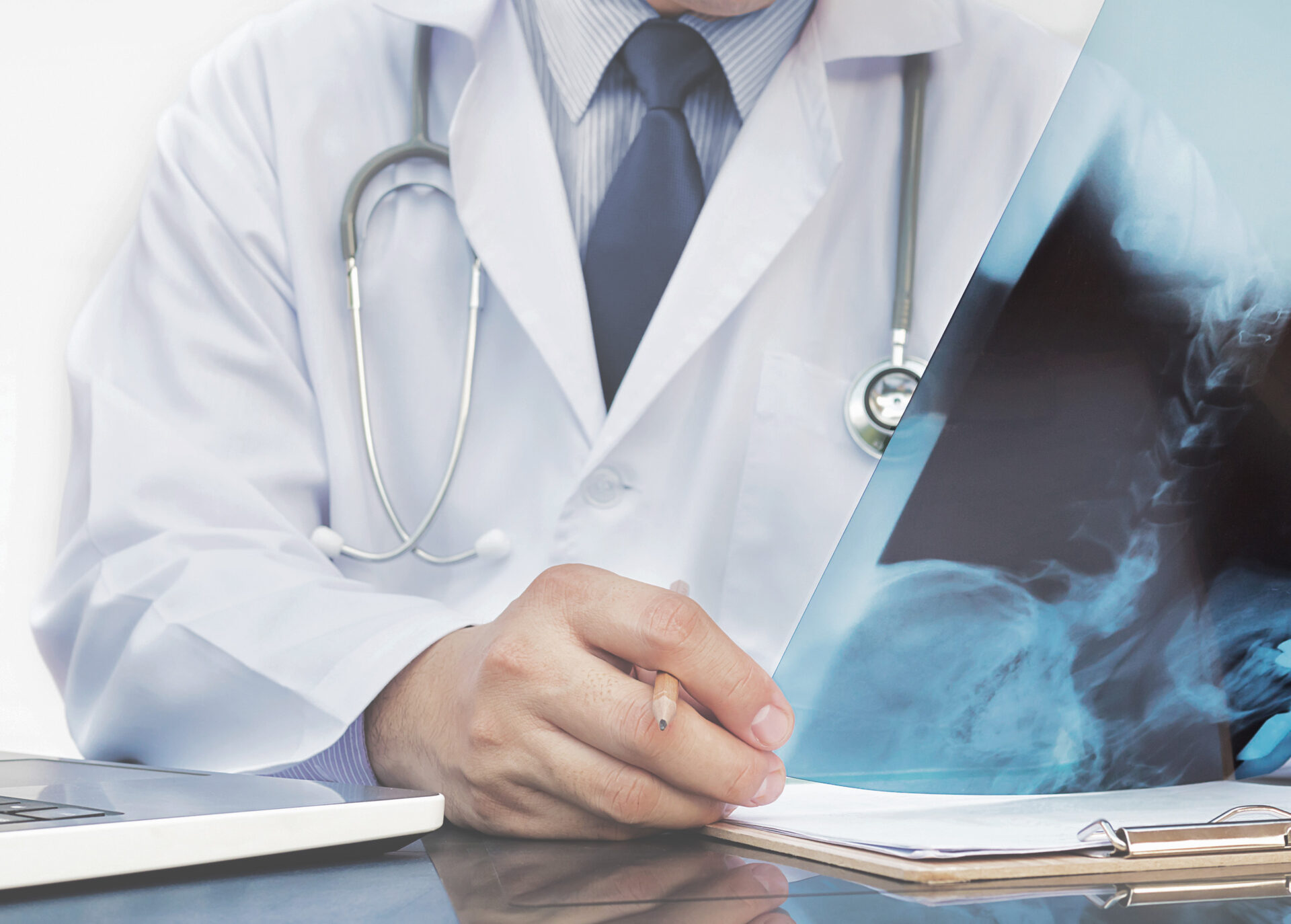 Doctor examine x ray film over white background